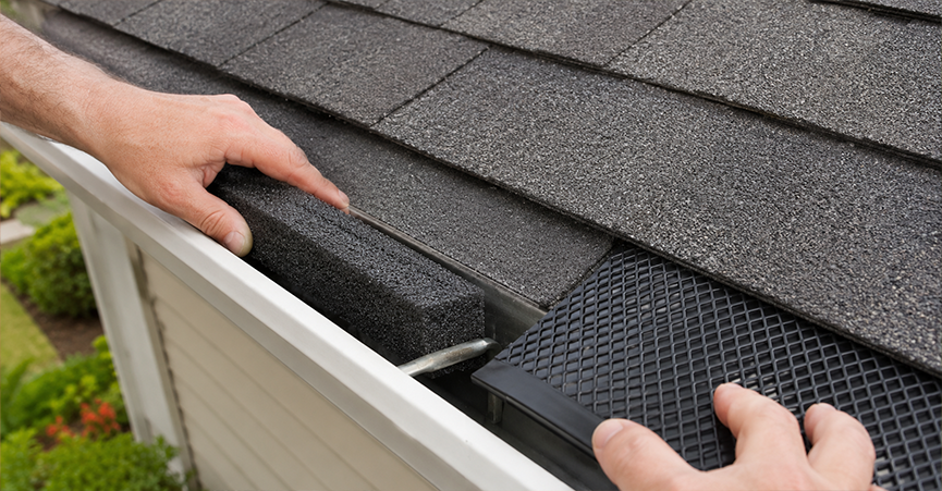 Side-by-side comparison of DIY installation methods, showing a foam gutter guard insert on the left and a snap-in plastic mesh gutter guard on the right, both fitted on an asphalt shingle roof.